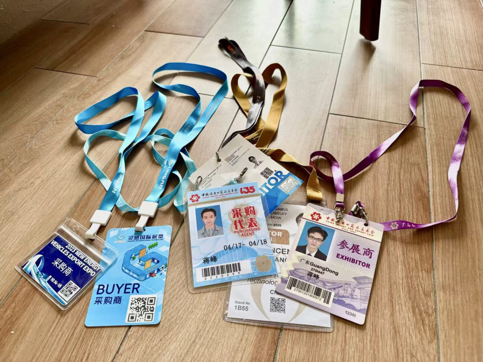Exhibitor badges from Canton Fair, New Energy Expo, and Hong Kong Jewellery Show representing years of hands-on trade show participation across industries