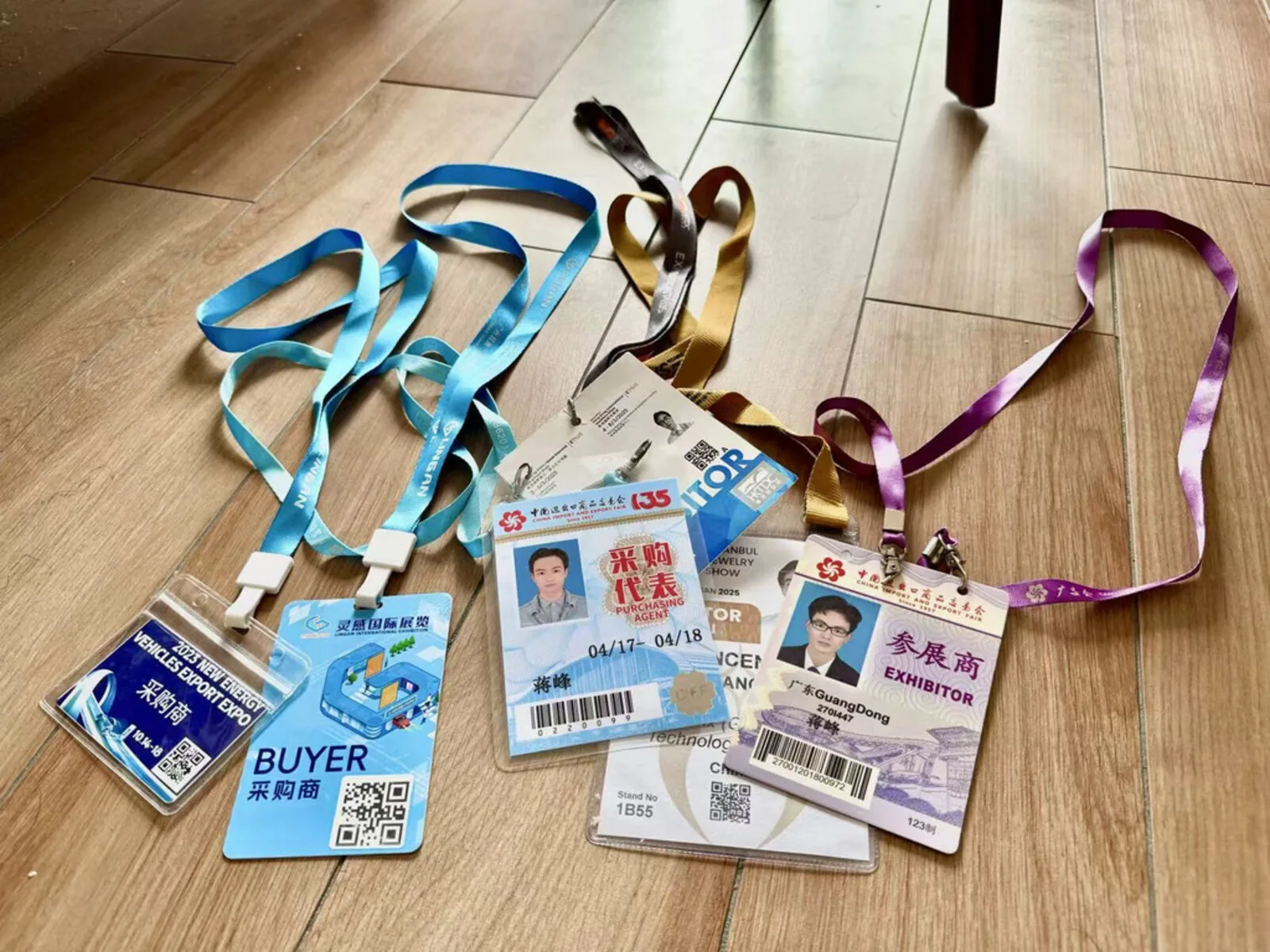 A collection of exhibitor badges from Canton Fair, New Energy Expo, and Hong Kong Jewellery Show accumulated over years of international trade participation